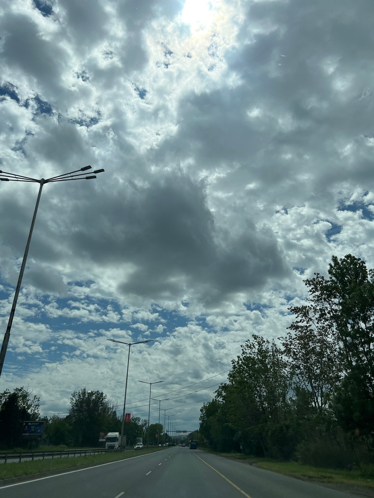 Vehicle travels through Burgas streets under cloudy skies