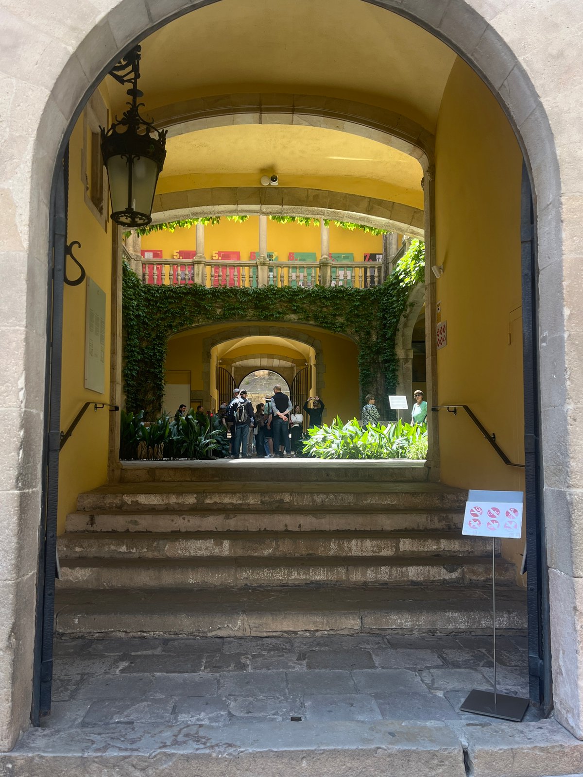 Tourist explores Barcelona's Gothic Quarter, documents historic architecture