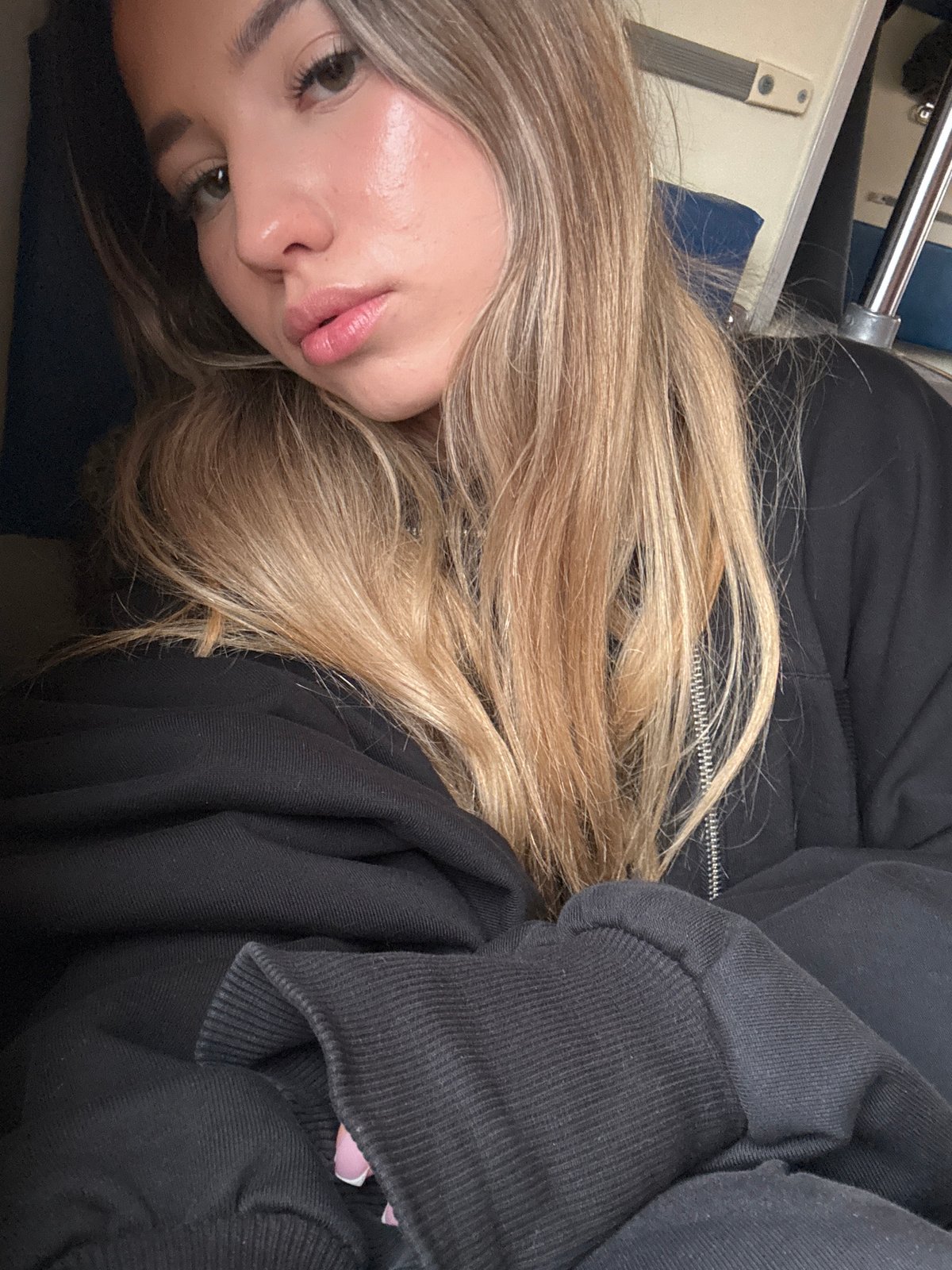 Woman rests on Moscow train during afternoon transit