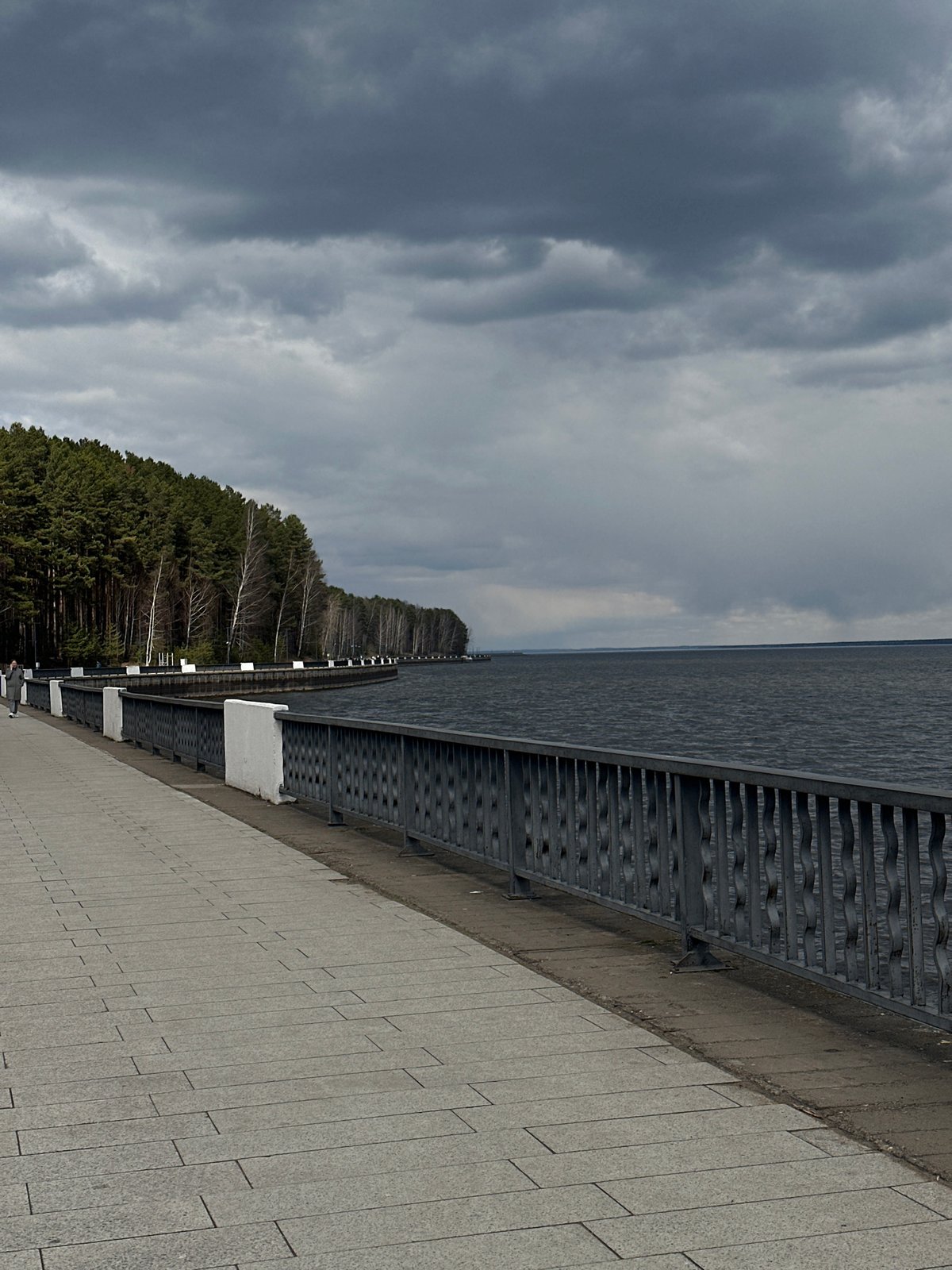 Overcast morning documented at waterfront promenade with bronze statue
