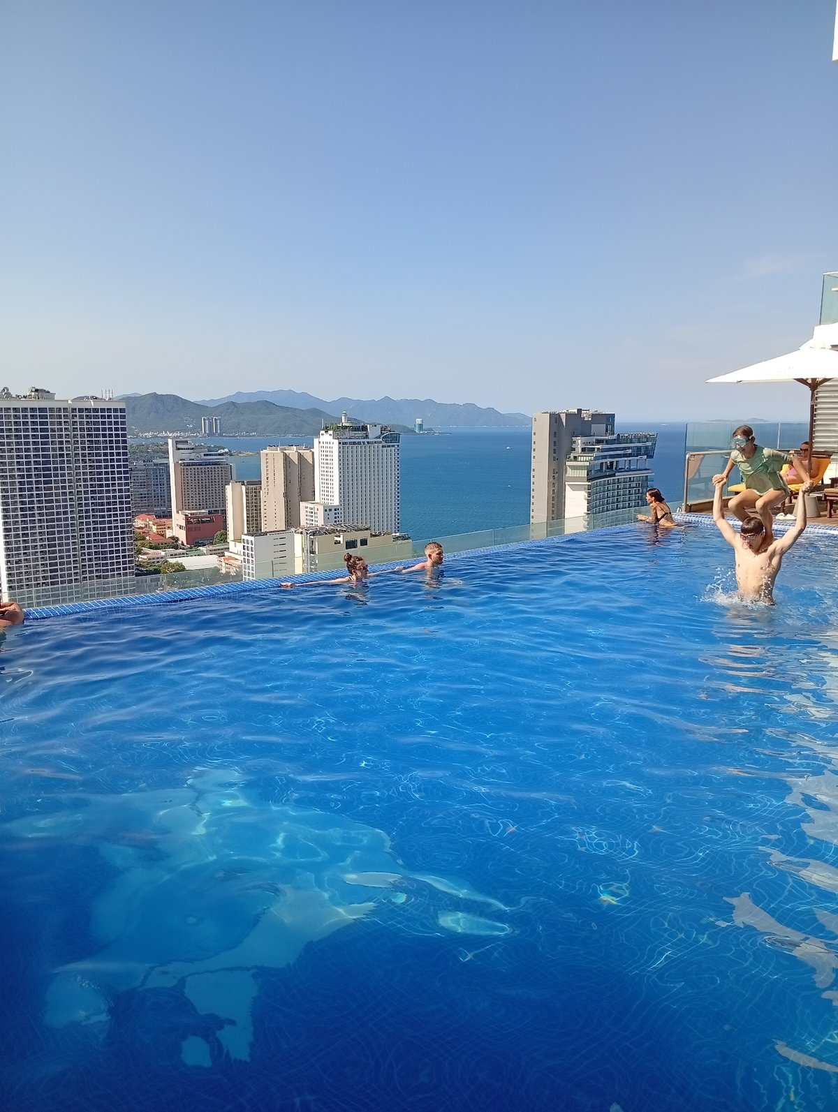 Nha Trang morning: rooftop pools, street life, and open-fire cooking