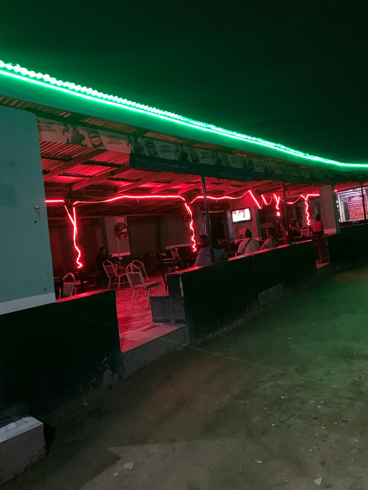 Person enjoys yellow fruit near Nigeria stadium establishments