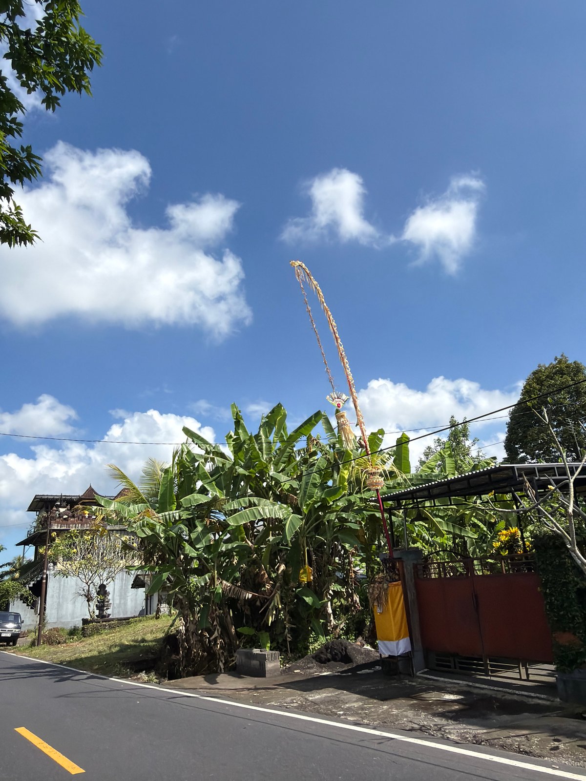 Tampaksiring street lined with Balinese temples and festival decorations