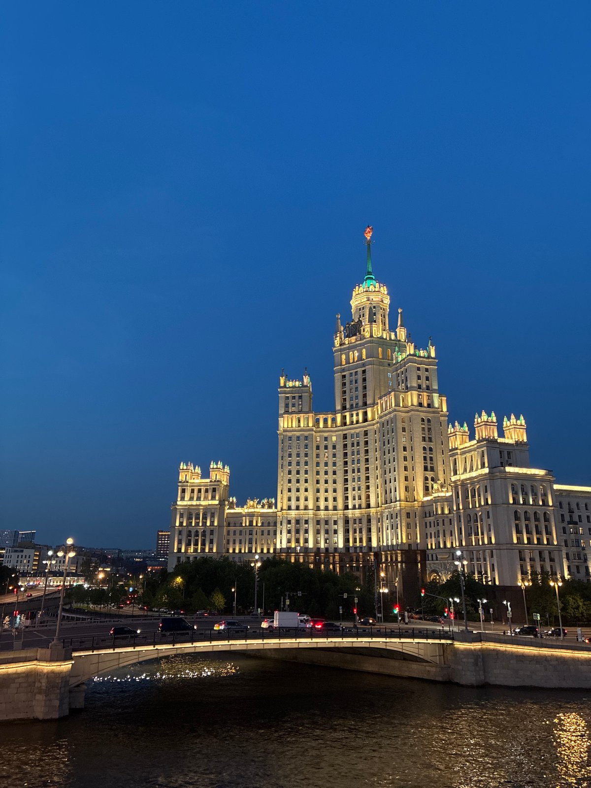 Moscow's Kotelnicheskaya Building illuminated against evening sky