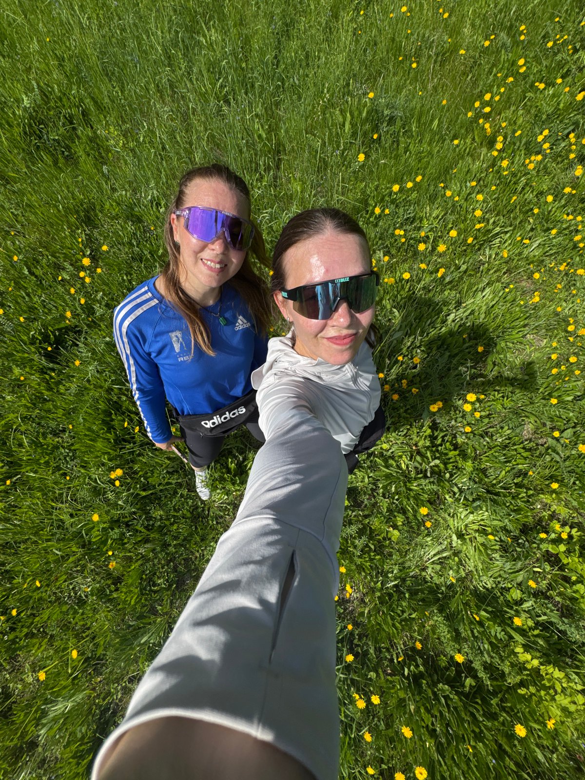 Women enjoy morning moment in dandelion field, Chaikovsky Russia