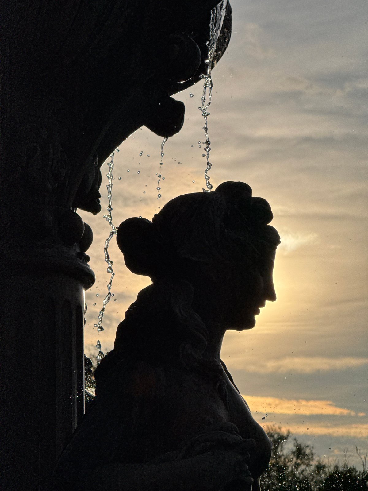 Sunset silhouettes captured at Minsk fountain monument