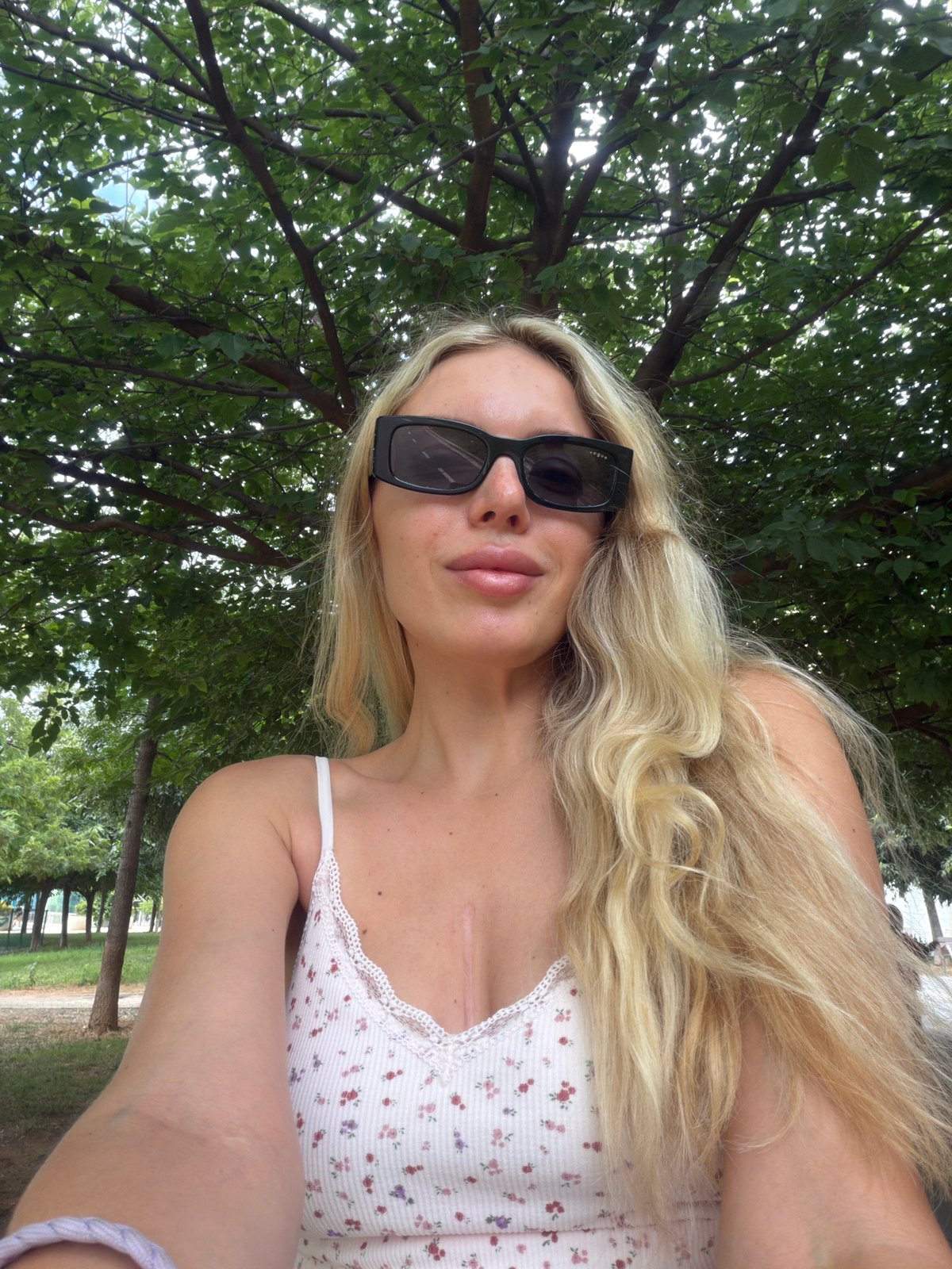Outdoor selfie under green tree canopy in suburban Valencia