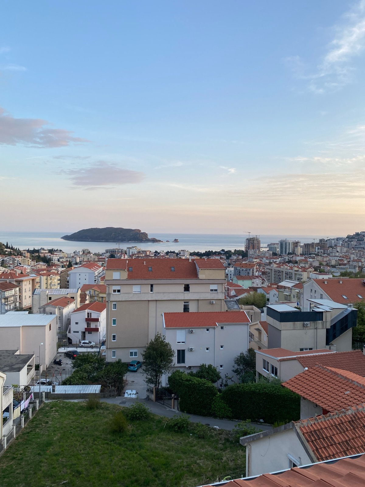 Witness documents evening views of Budva's coastal cityscape