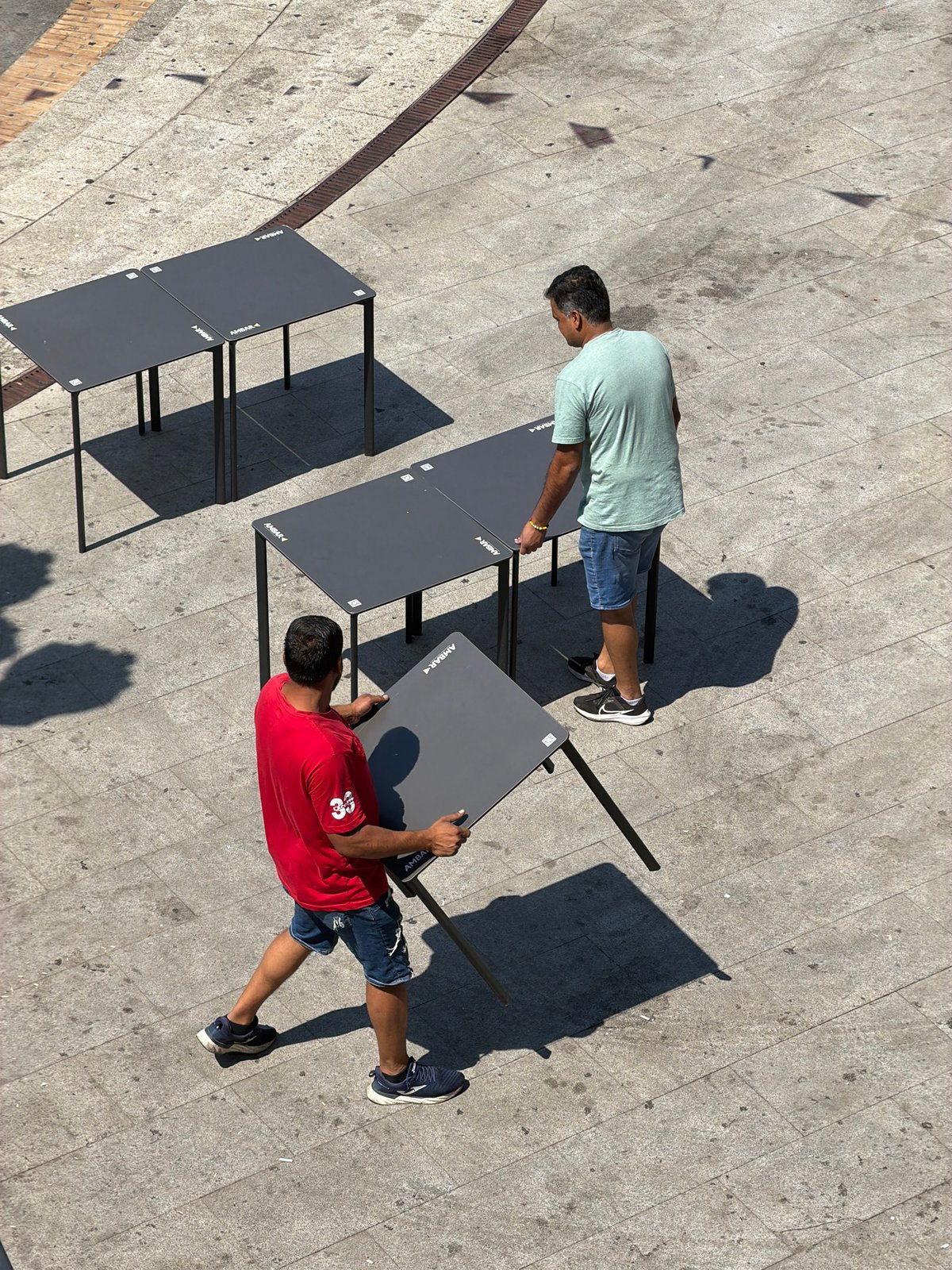 Outdoor table setup underway at a Las Rozas paved terrace