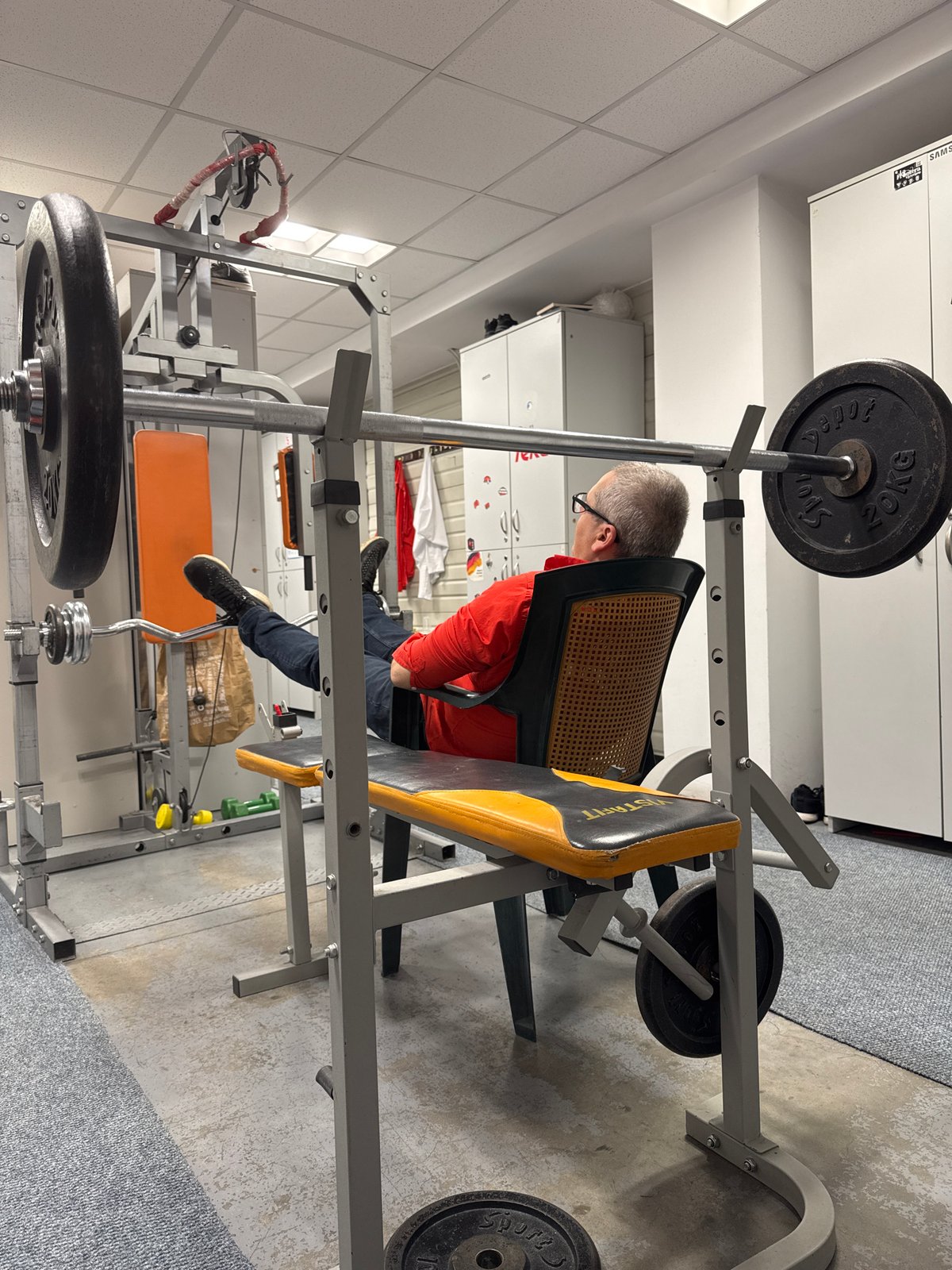Man sits on weight bench in Sofia home gym