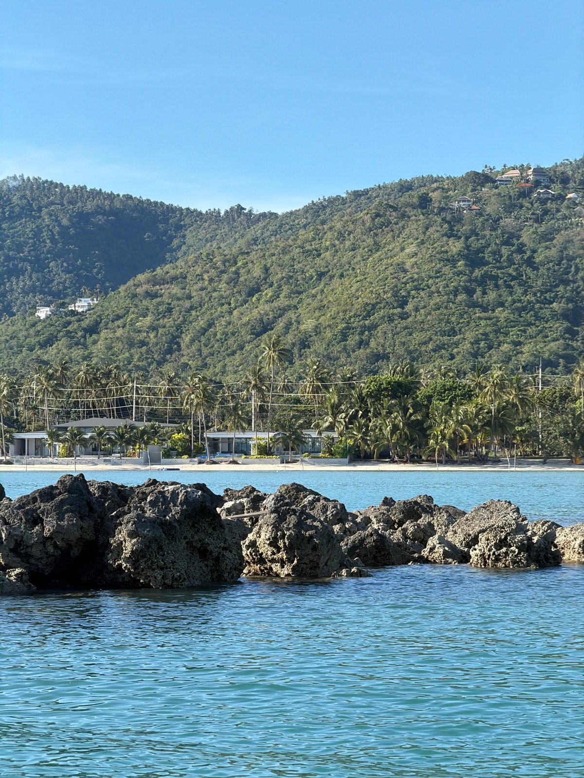 Boats and coastal activity at Baan Thong Krut's waterfront