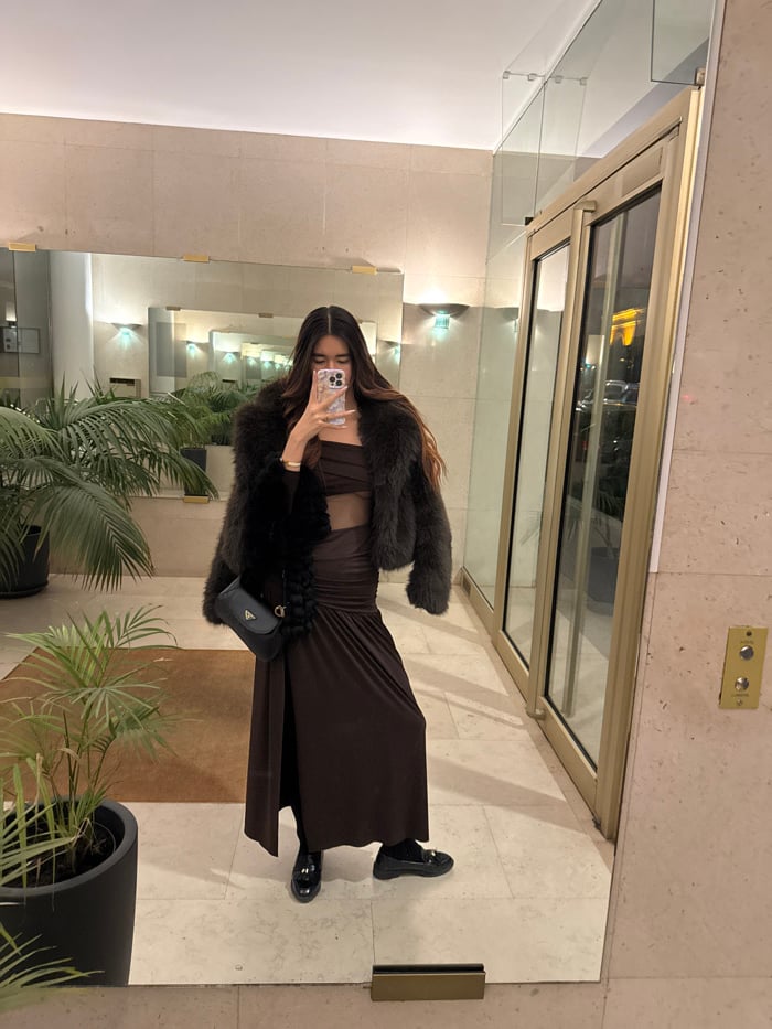 Woman takes mirror selfies in brown dress, Paris