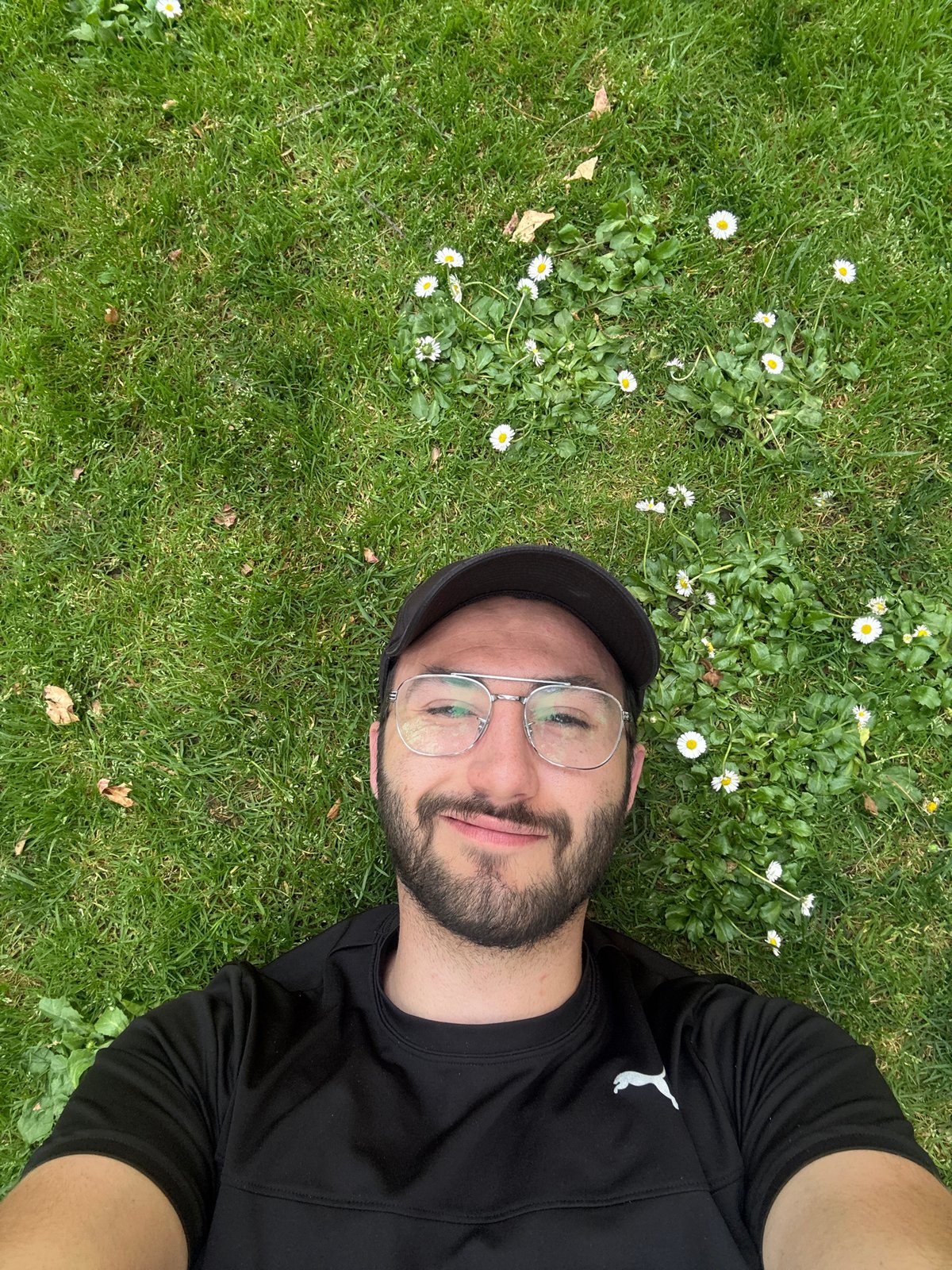 Man rests among daisies in Mexico park setting