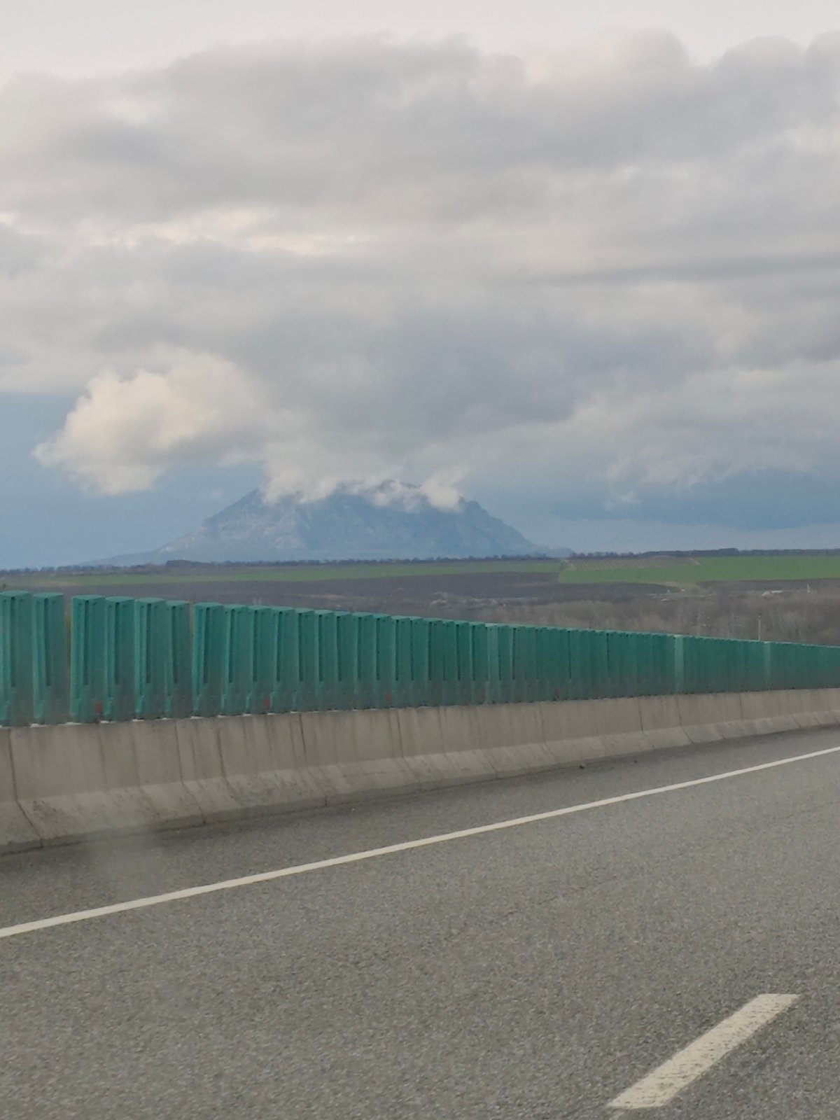 Highway scene documented in Konstantinovskaya with mountain backdrop