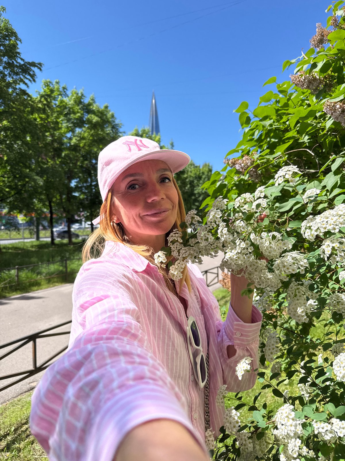 Woman documents spring flower blooms in Saint Petersburg park