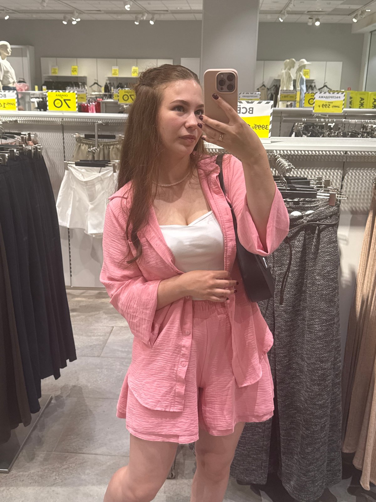 Trying on a pink two-piece set in an Izhevsk clothing store