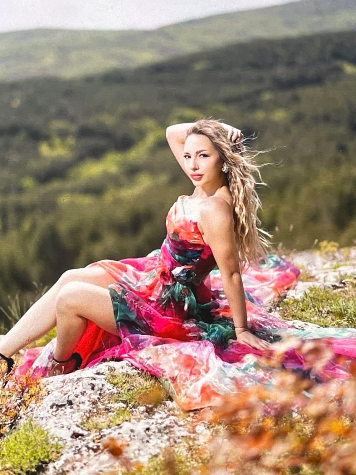 Woman poses for photos on rocky outcrop