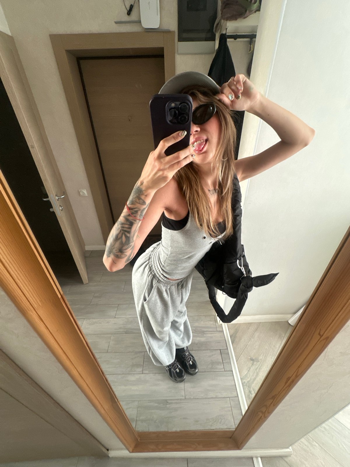 Mirror selfies in grey outfit at Moscow apartment