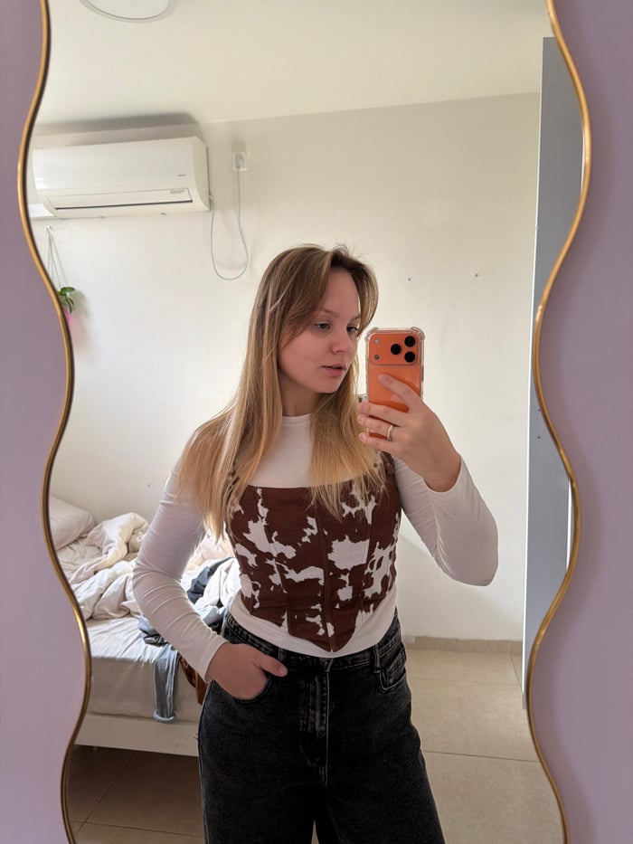 Woman takes mirror selfies in Tel Aviv bedroom