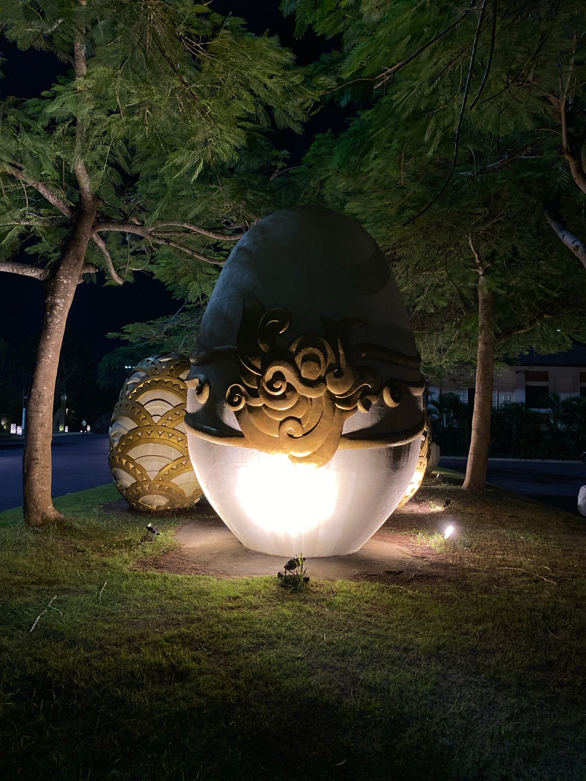 Evening resort visit with illuminated sculptures and poolside scenes