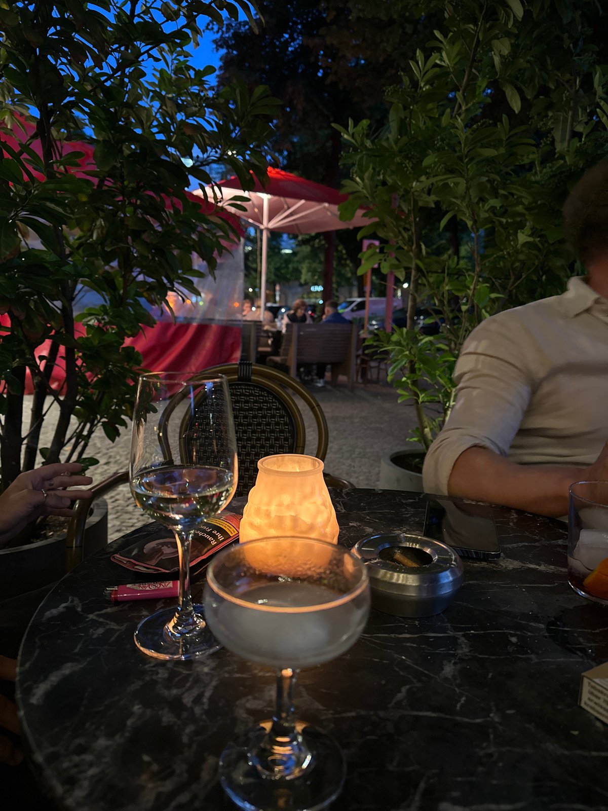 Evening dining scene captured at Berlin outdoor terrace