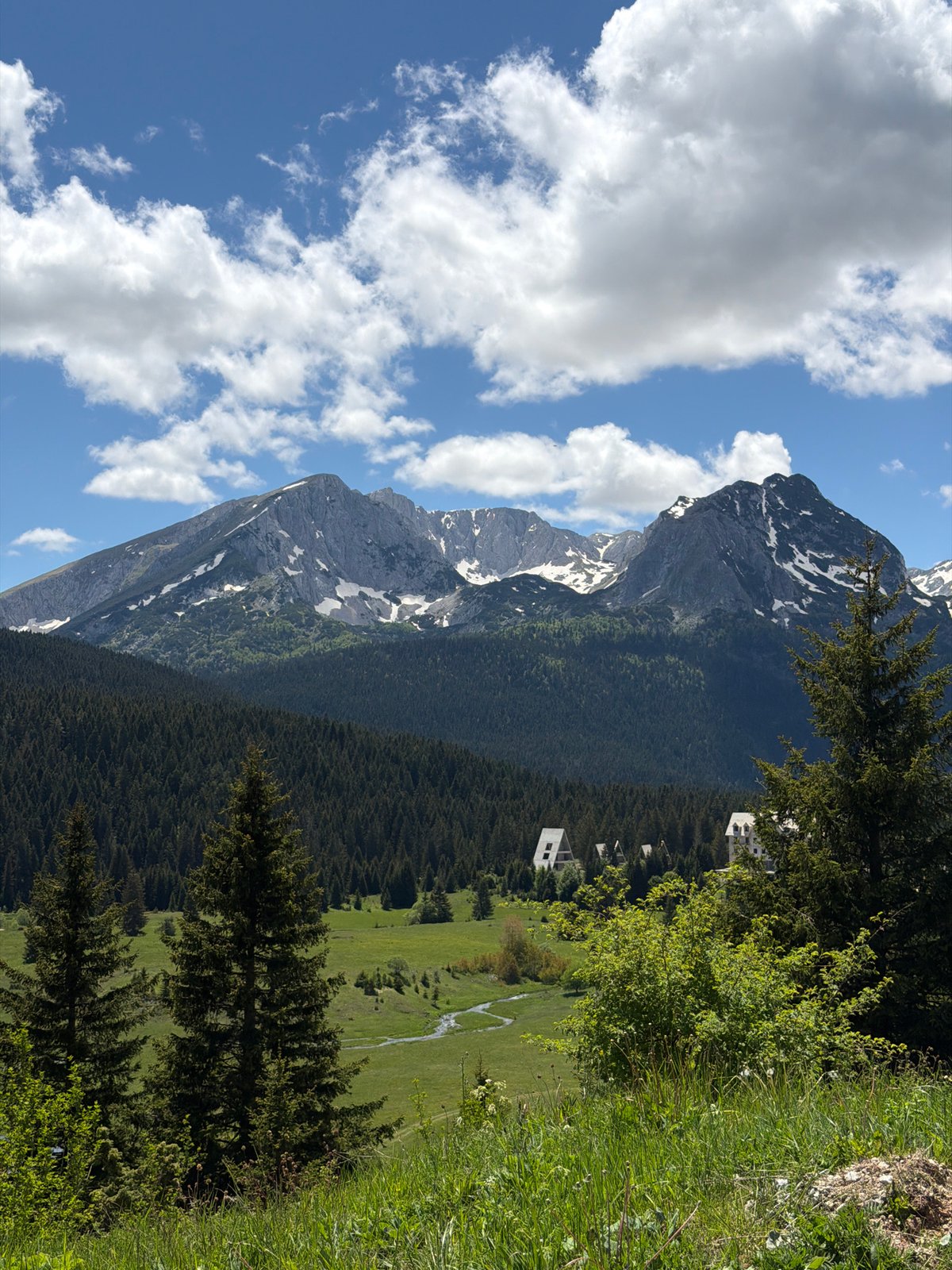 Tourist plays with shadows amid Montenegro's mountain scenery
