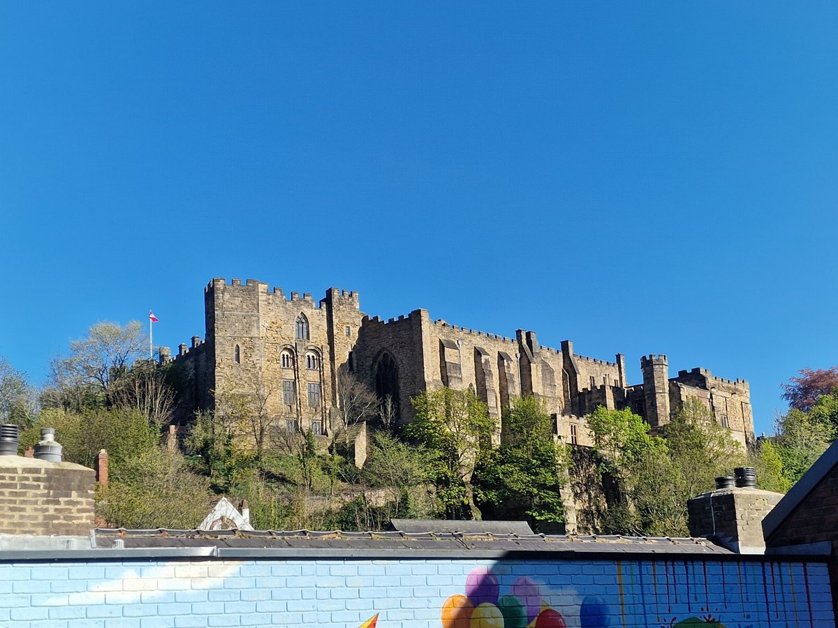 Durham Castle observed under clear skies with red flag
