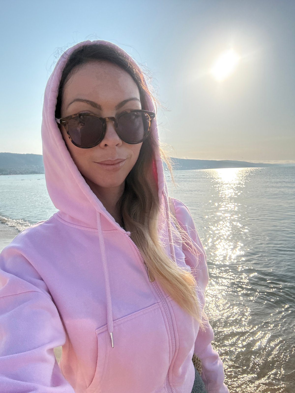 Woman takes coastal selfie in Nesebar, Bulgaria