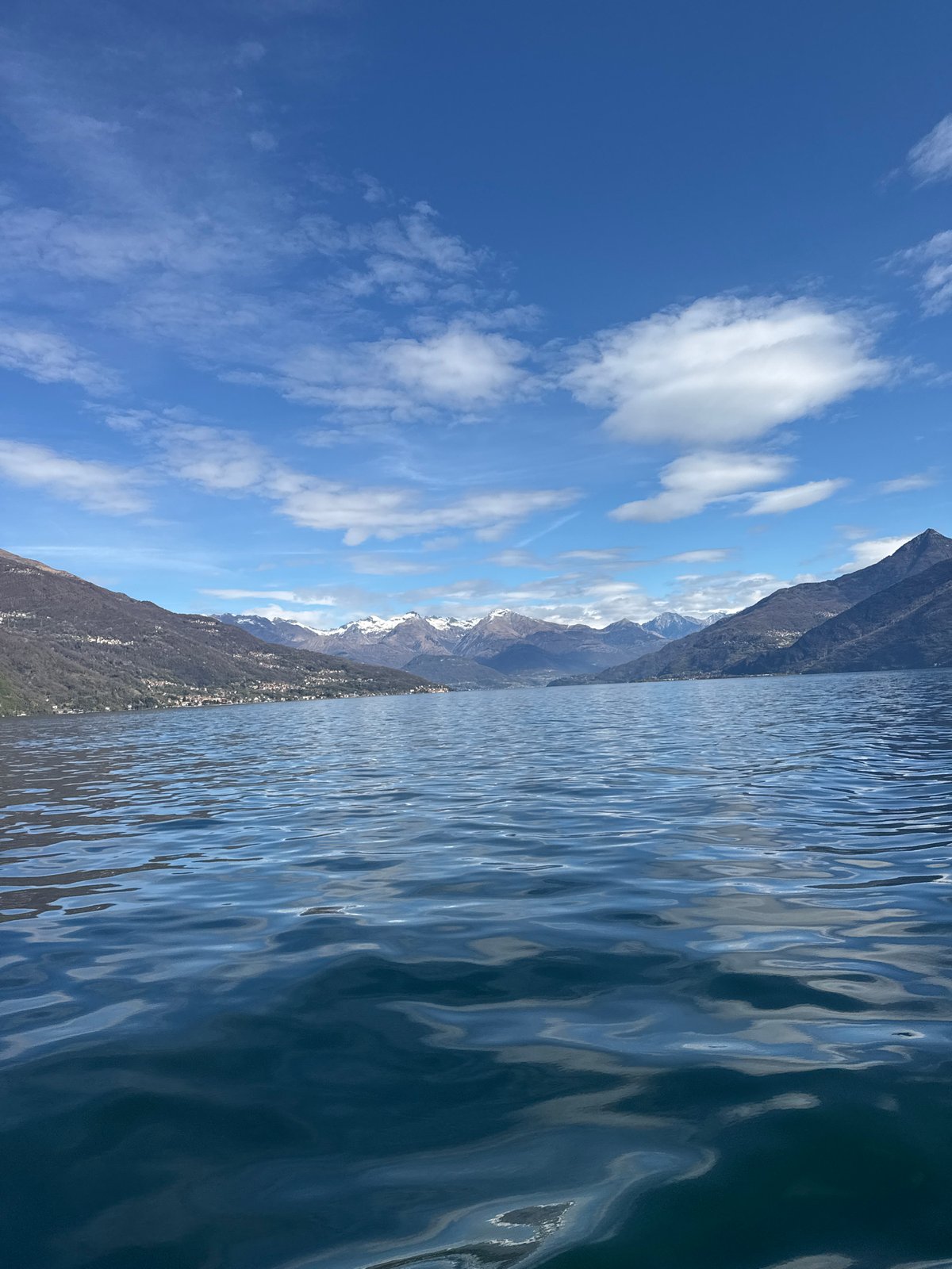 Lake Como viewed from Nobiallo showing rippling waters, mountains