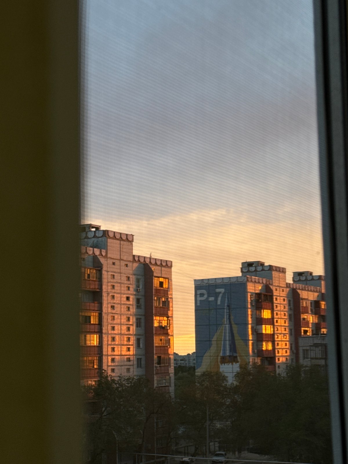 Sunset over Baikonur's Soviet apartment blocks, rockets on the walls