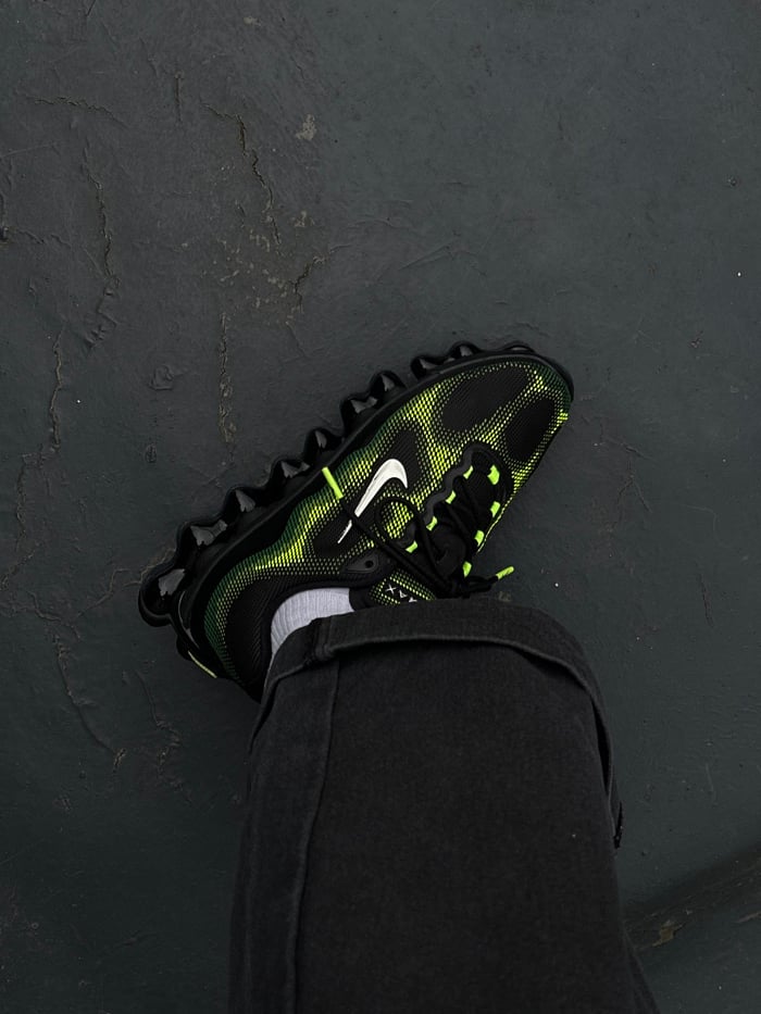 Person in neon sneakers spotted on wet London pavement
