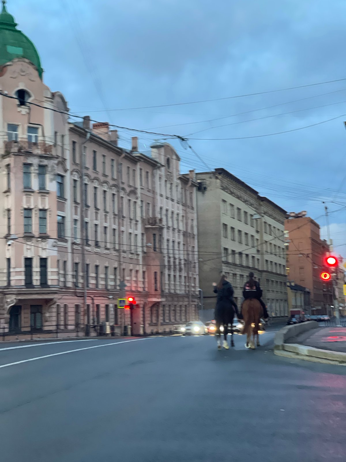 Rainy evening streets and horseback riders in Saint Petersburg