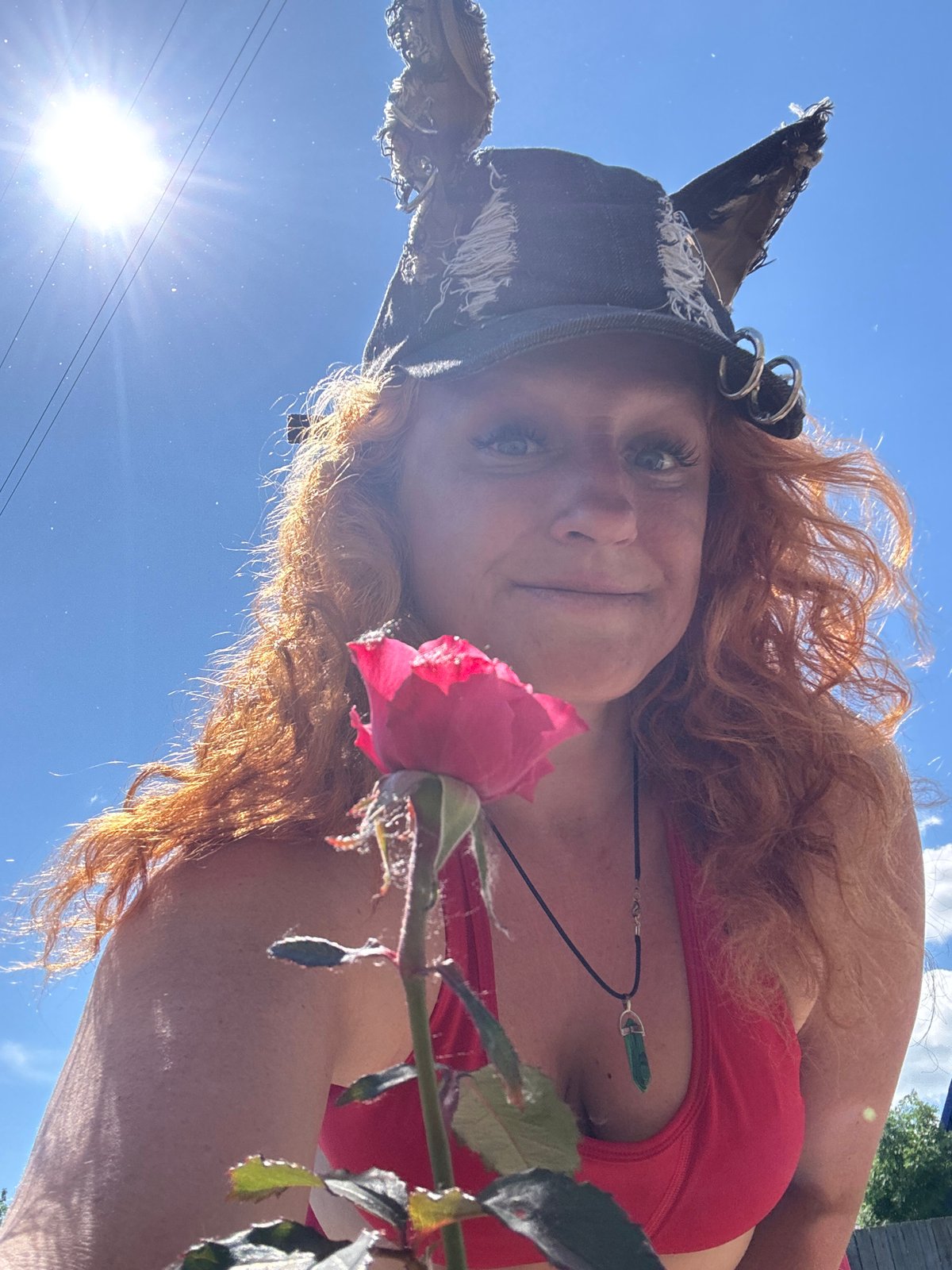 Red-haired woman in cat-ear hat photographed in Chaikovsky