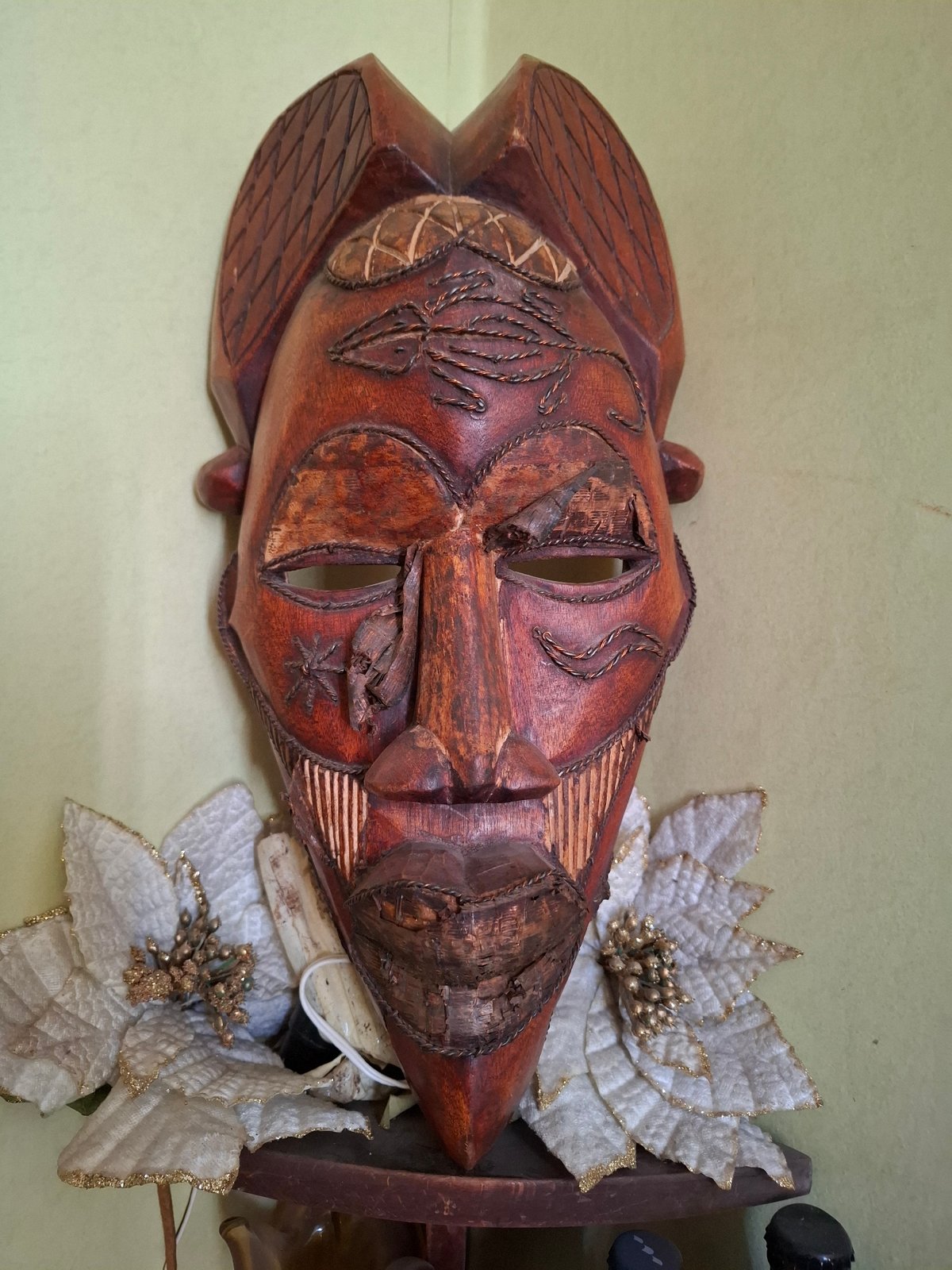 Wooden mask with artificial flowers observed in Sofia