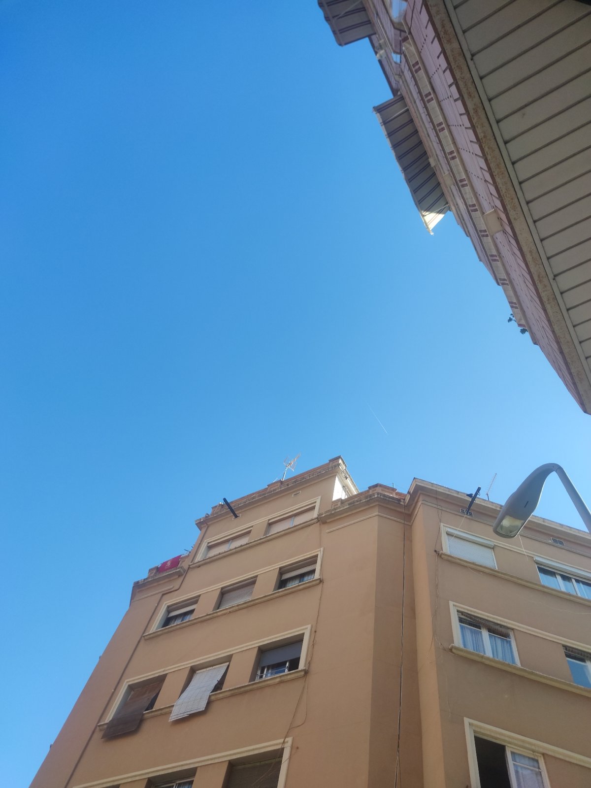 Urban architectural documentation captures building facades under clear skies