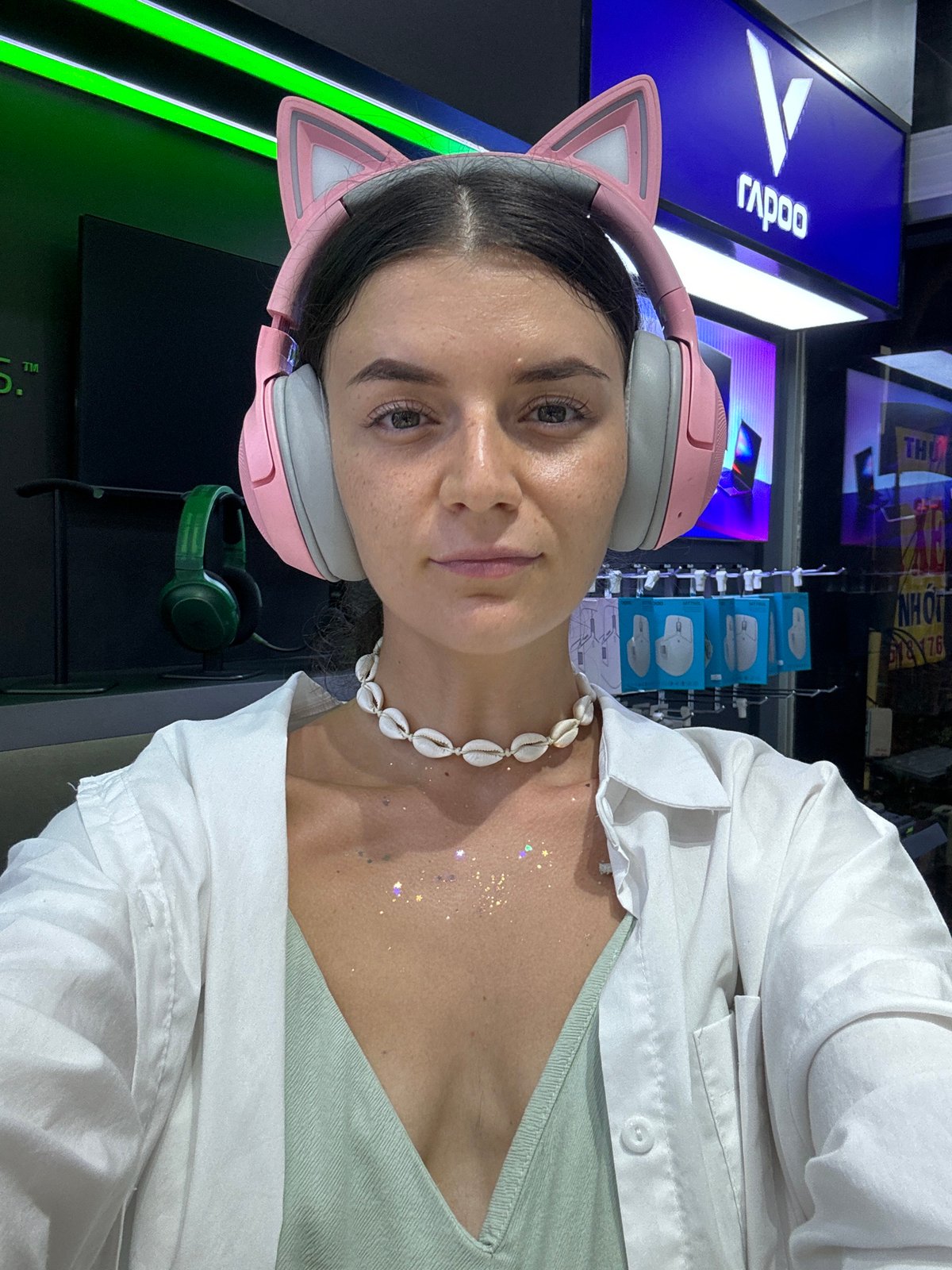 Woman in cat-ear headphones photographed indoors in Thuận An