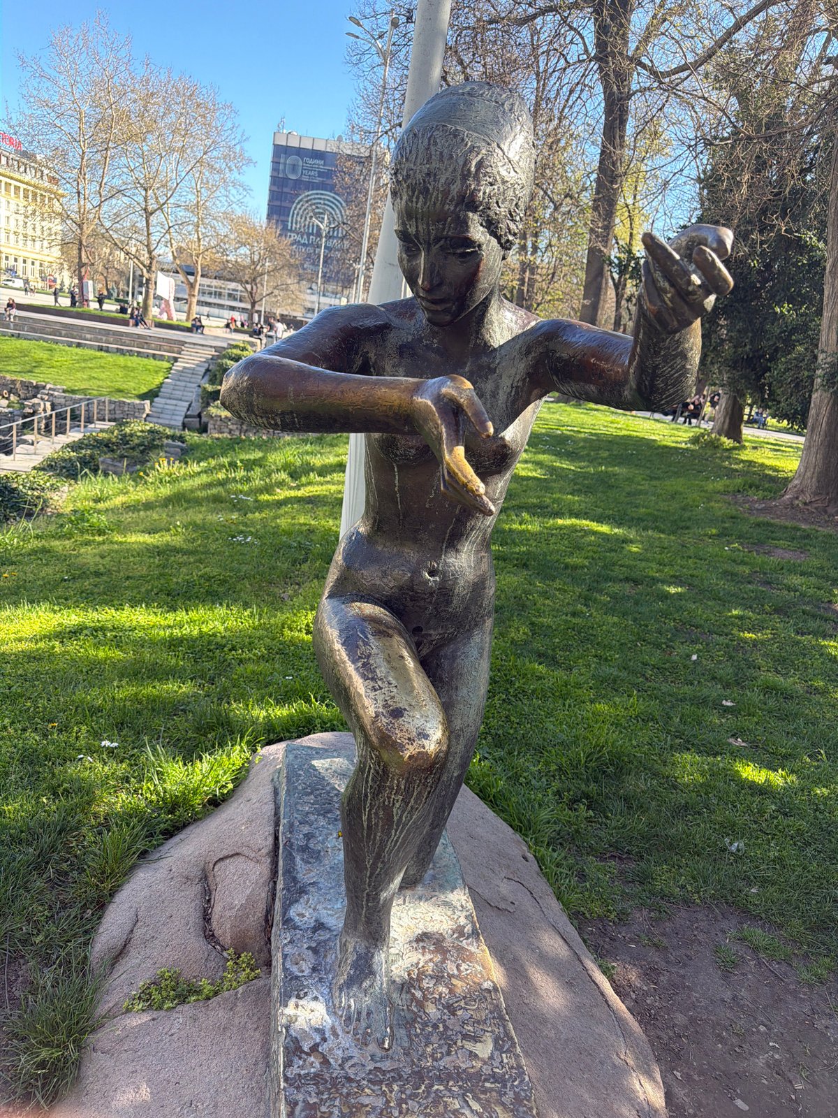 Person photographs park monument with smartphone