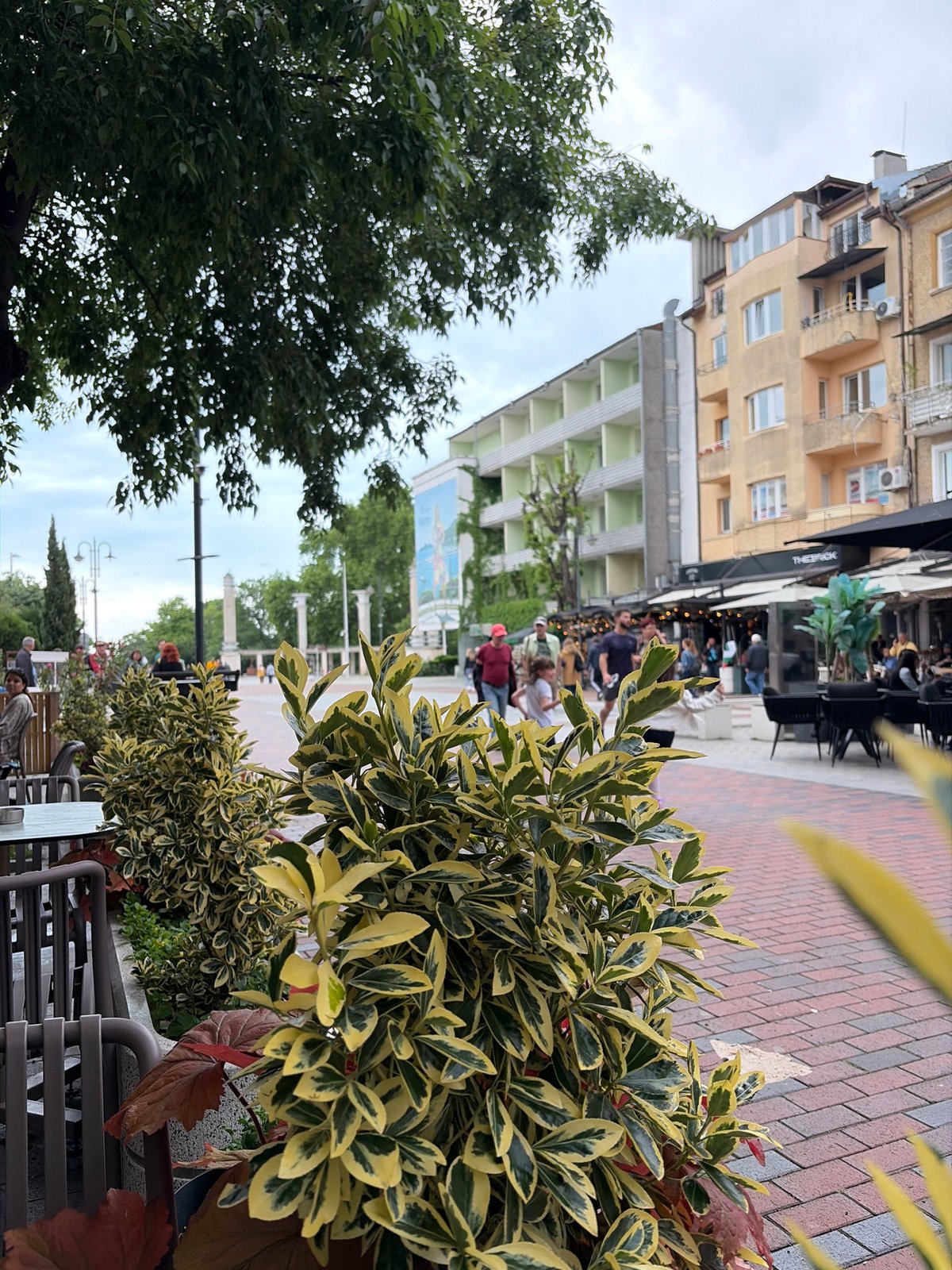 Morning street scene with café seating observed in Varna