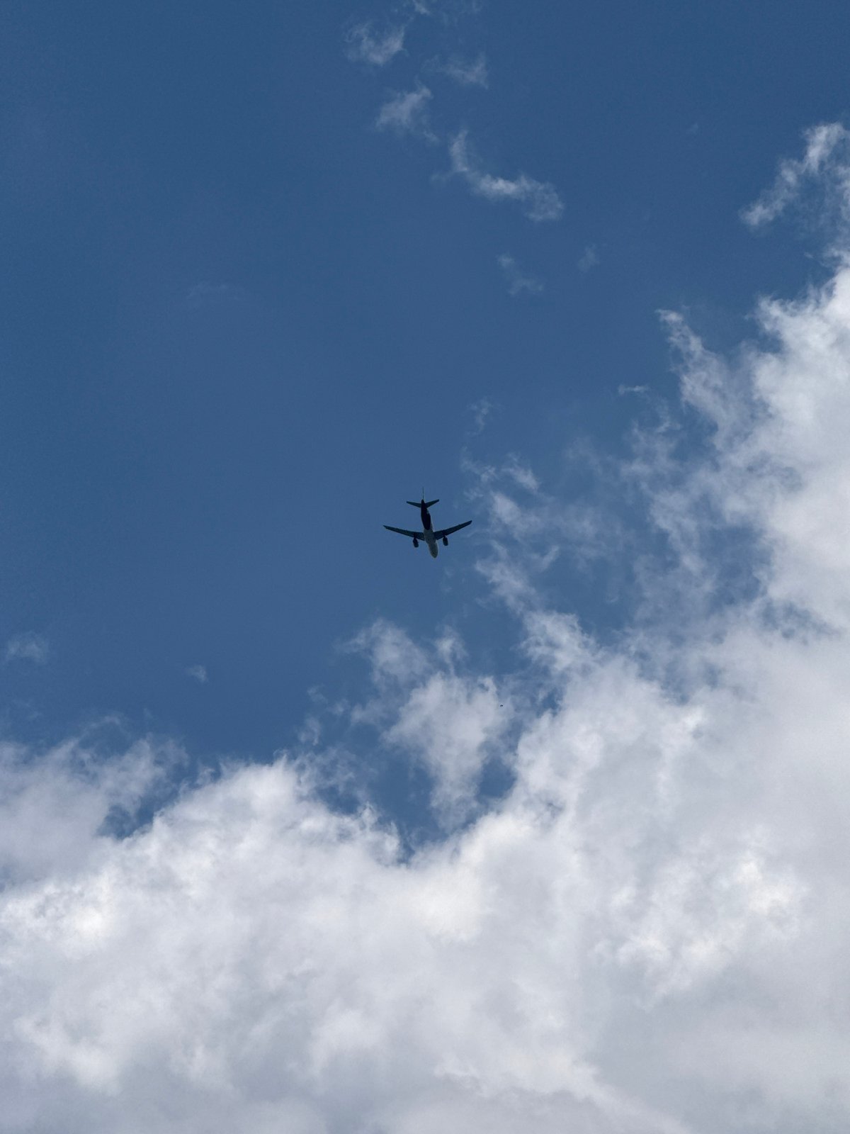 Plane silhouette against blue sky over Sveti Vlas