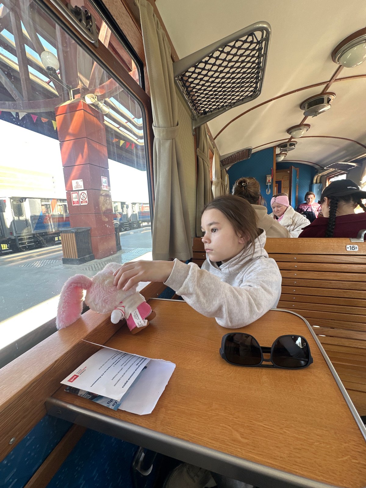 Girl plays with stuffed rabbit on train in Yekaterinburg