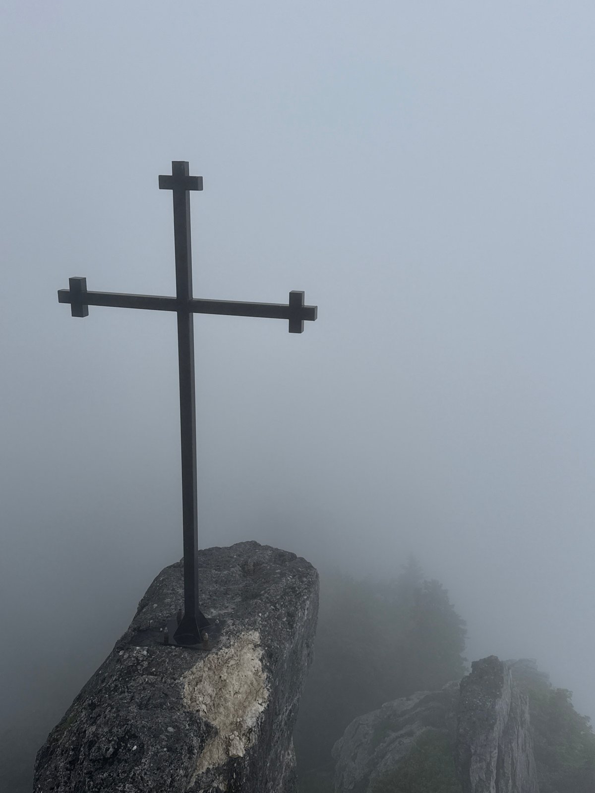 Foggy cross-marked rocky outcrop in Dzirovani, Georgia