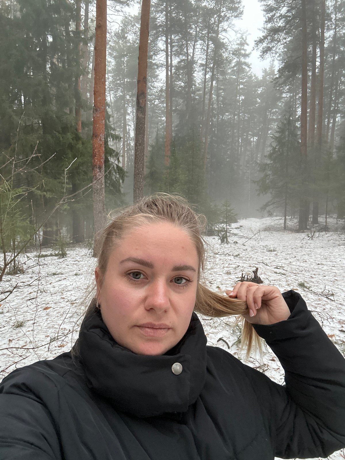 Woman takes winter selfies in foggy Russian forest
