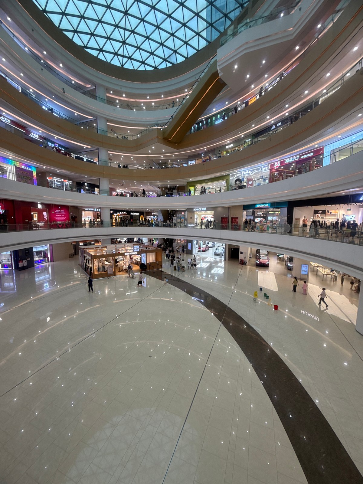 Neon arcades and grand opening flowers inside a Qinhuangdao mall