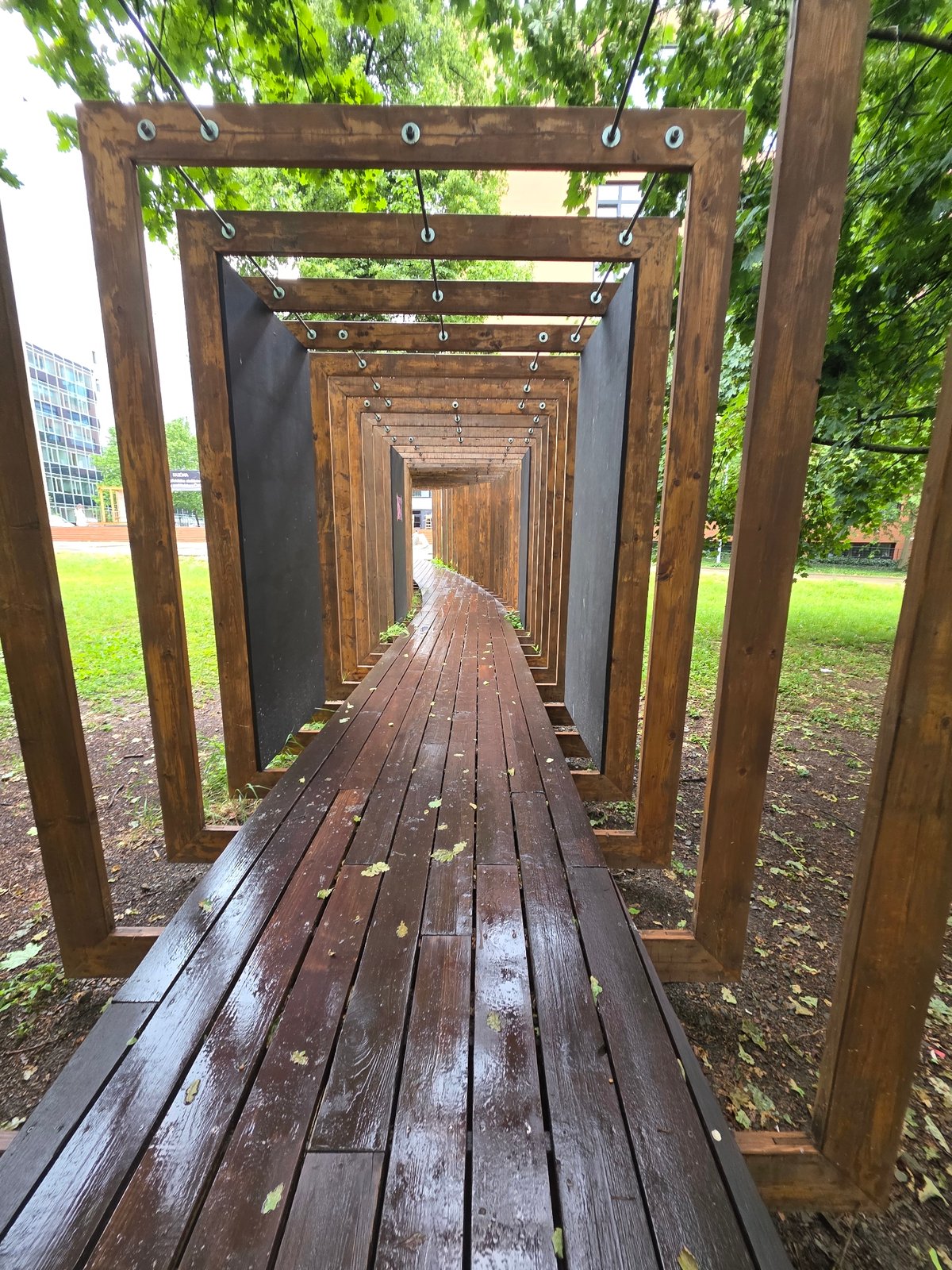 Wooden tunnel structure photographed from elevated perspective