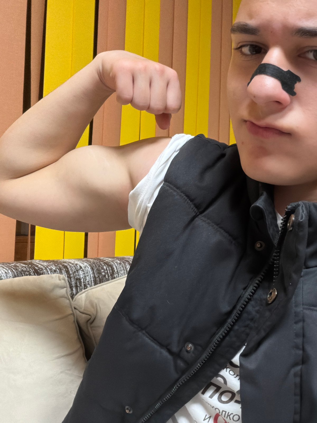 Person flexes arm indoors in Panagyurishte residential setting
