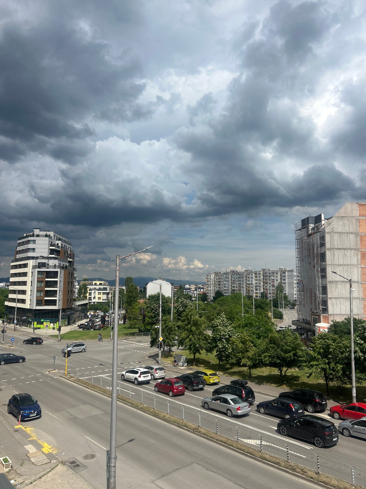 Dramatic clouds observed over busy Sofia street from elevated viewpoint