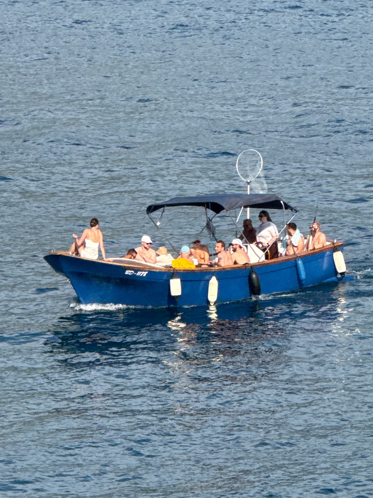 Boats and jet skis cruising the Budva coastline on a summer afternoon
