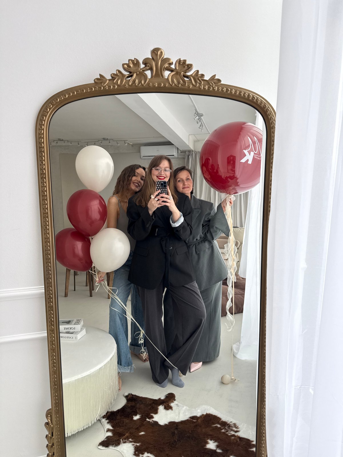 Women take selfie with balloons in ornate mirror, Izhevsk