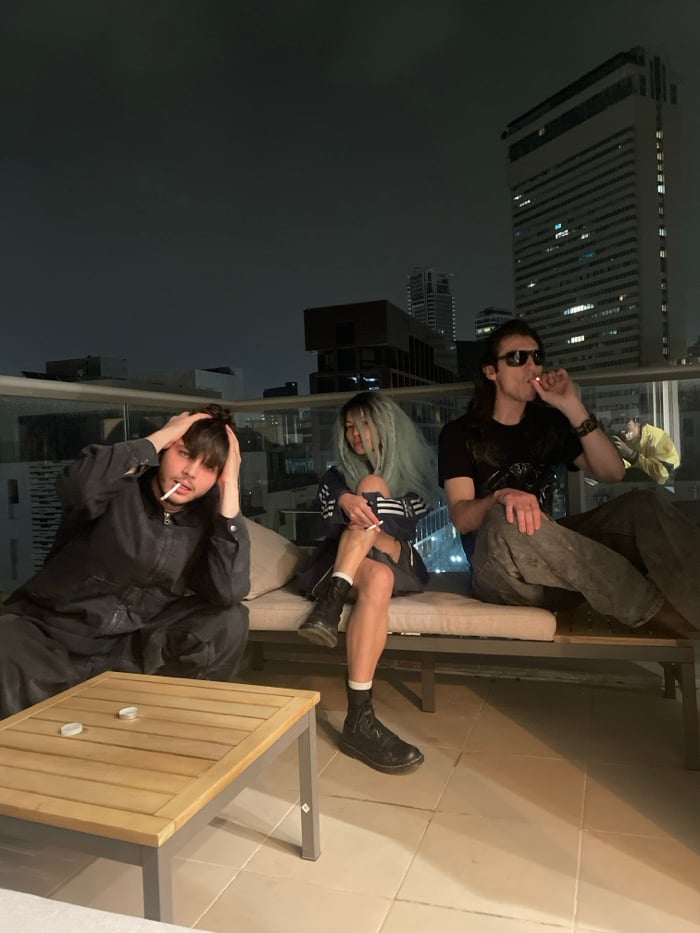 Young adults socialize on Tel-Aviv rooftop terrace Friday night
