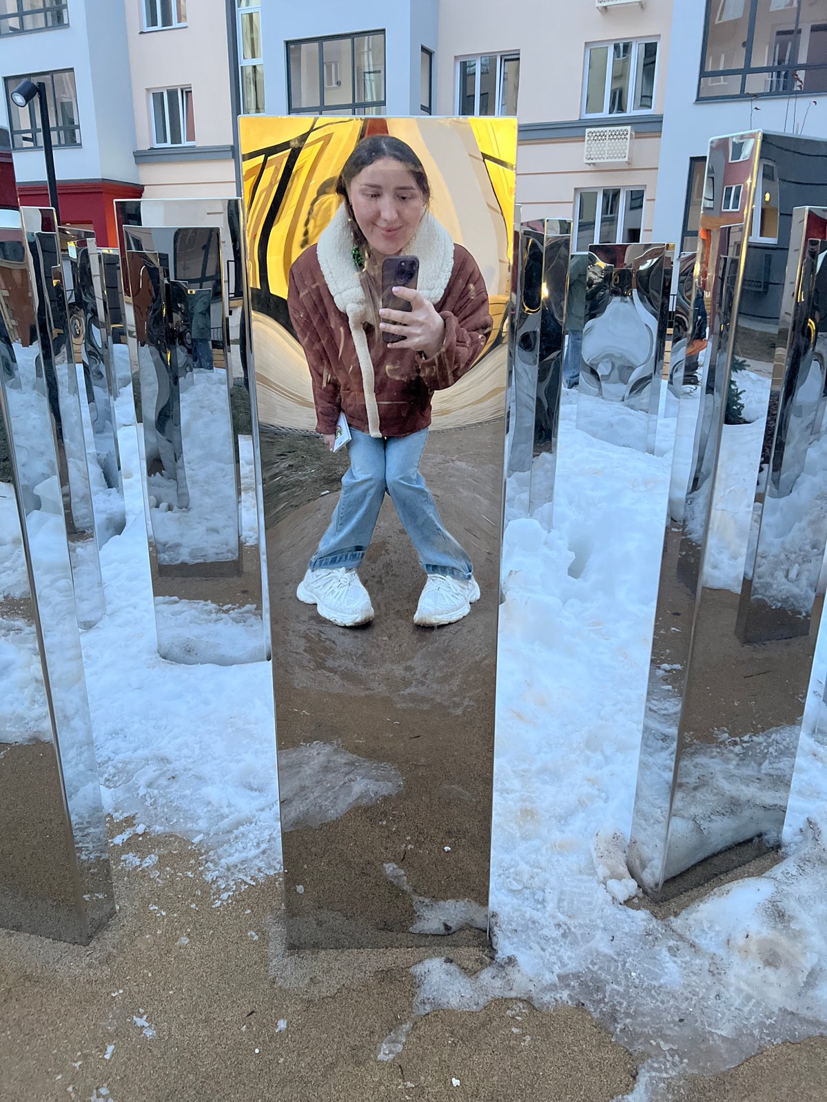 Woman takes selfies at mirrored art installation in Russia